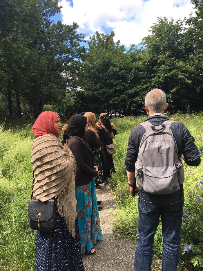 Picture of group of people exploring greenery with a walk guide